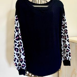 Black knit shirt with contrast leopard sleeves